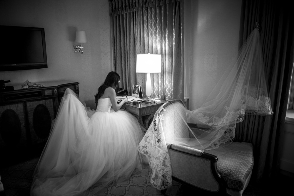 a bride writing her vow before wedding